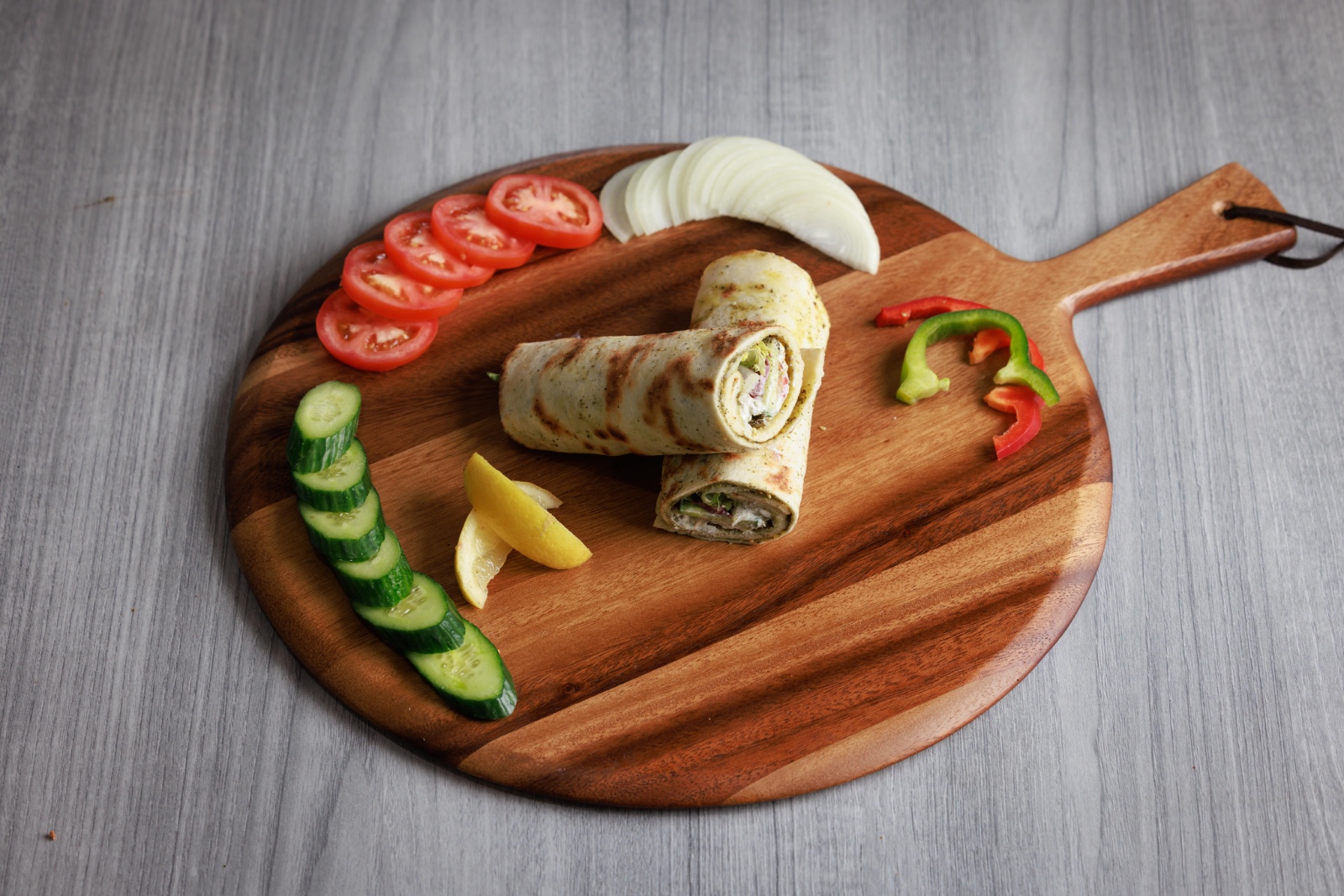 Sliced zaatar wrap served with fresh vegetables